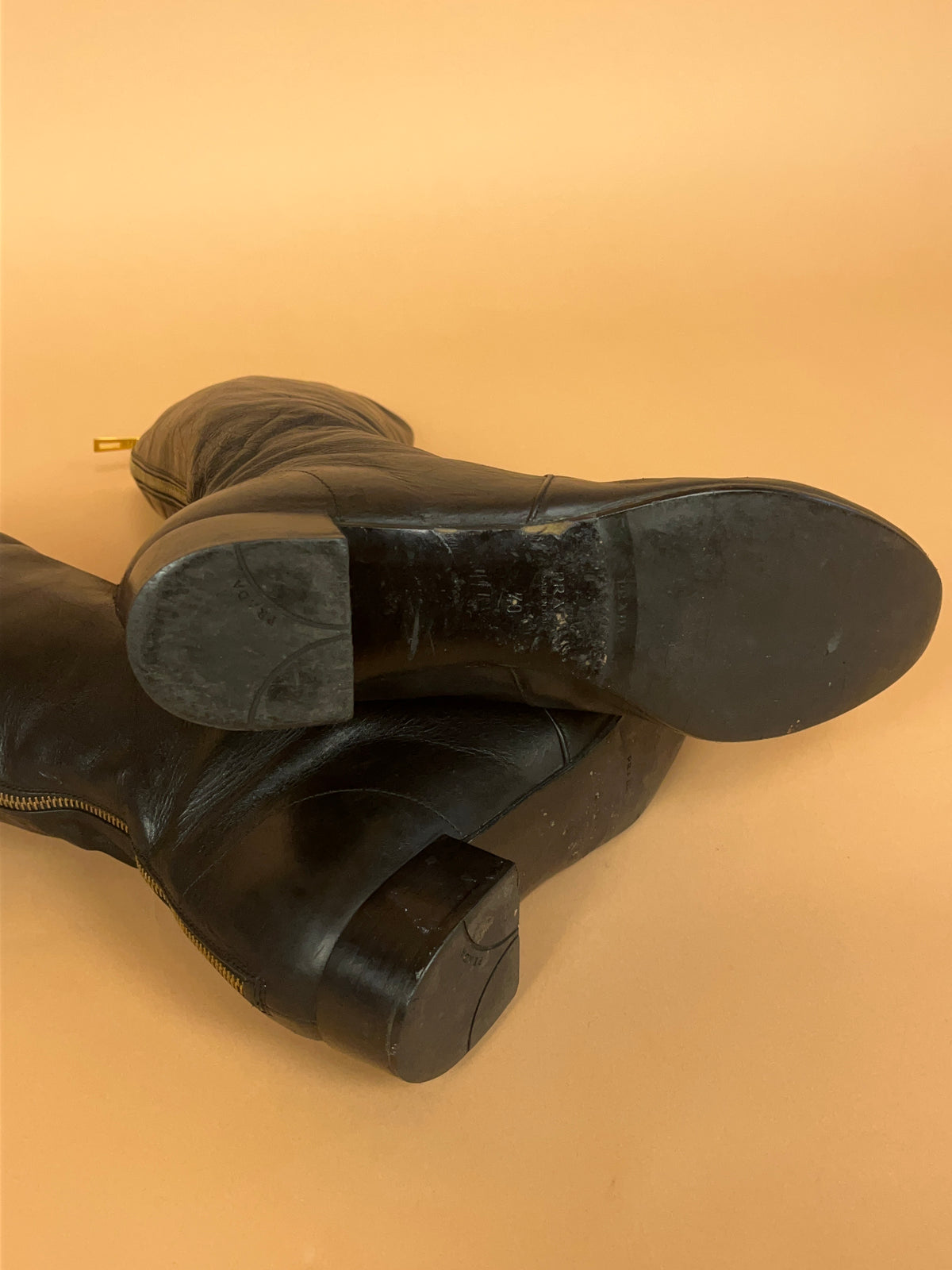 Y2K Prada crinkled black leather knee-high boots with gold-tone zip pull — Arkive Vintage