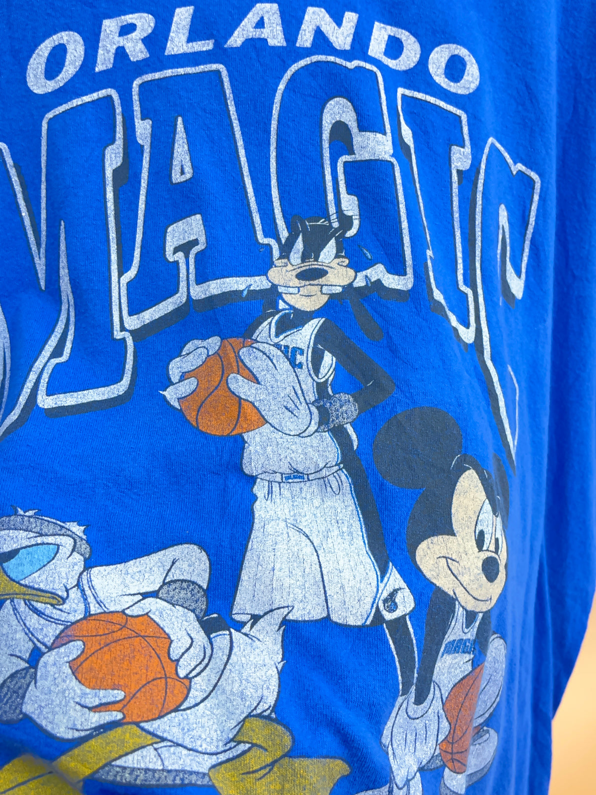 Y2K Orlando Magic Disney NBA t-shirt in blue with cracked graphic print — Arkive Vintage